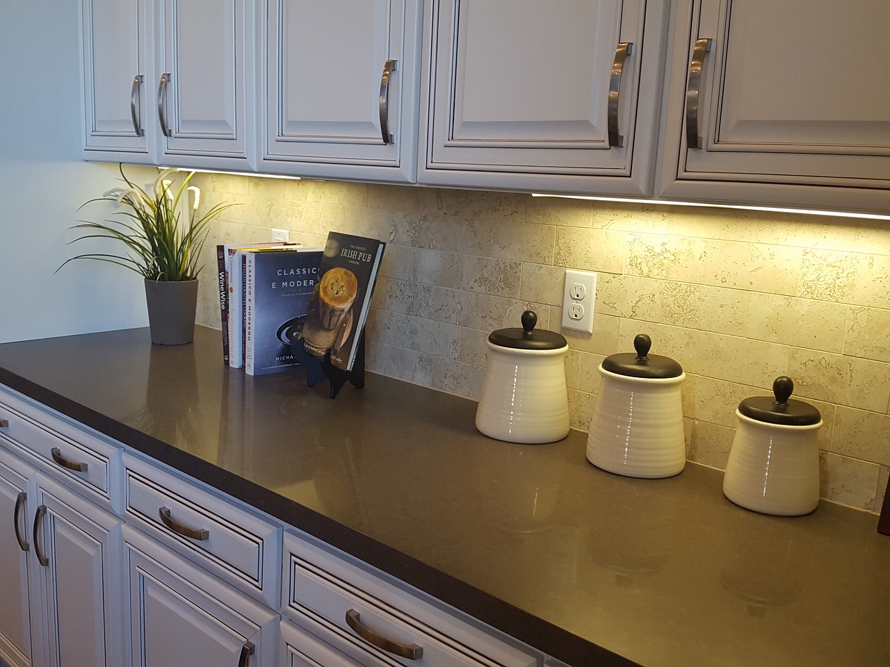 kitchen counter with cookbooks and jars